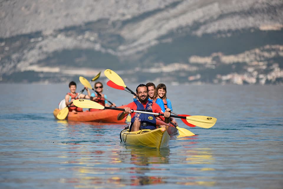 Sea kayaking along the wild coastline of Brač Island, Croatia